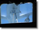 Looking out the cockpit window as the KC-10 fuel operator guides the refueling pipe towards us.