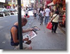 An artist painting in China Town.