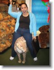 Ashley riding a stuffed cheetah inside FAO Schwarz.