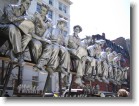 Silver faux construction worker statues on a truck in SoHo.