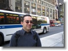 A bus behind Juston in Times Square.