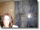 Ashley by the Rock Center Cafe entrance sign.